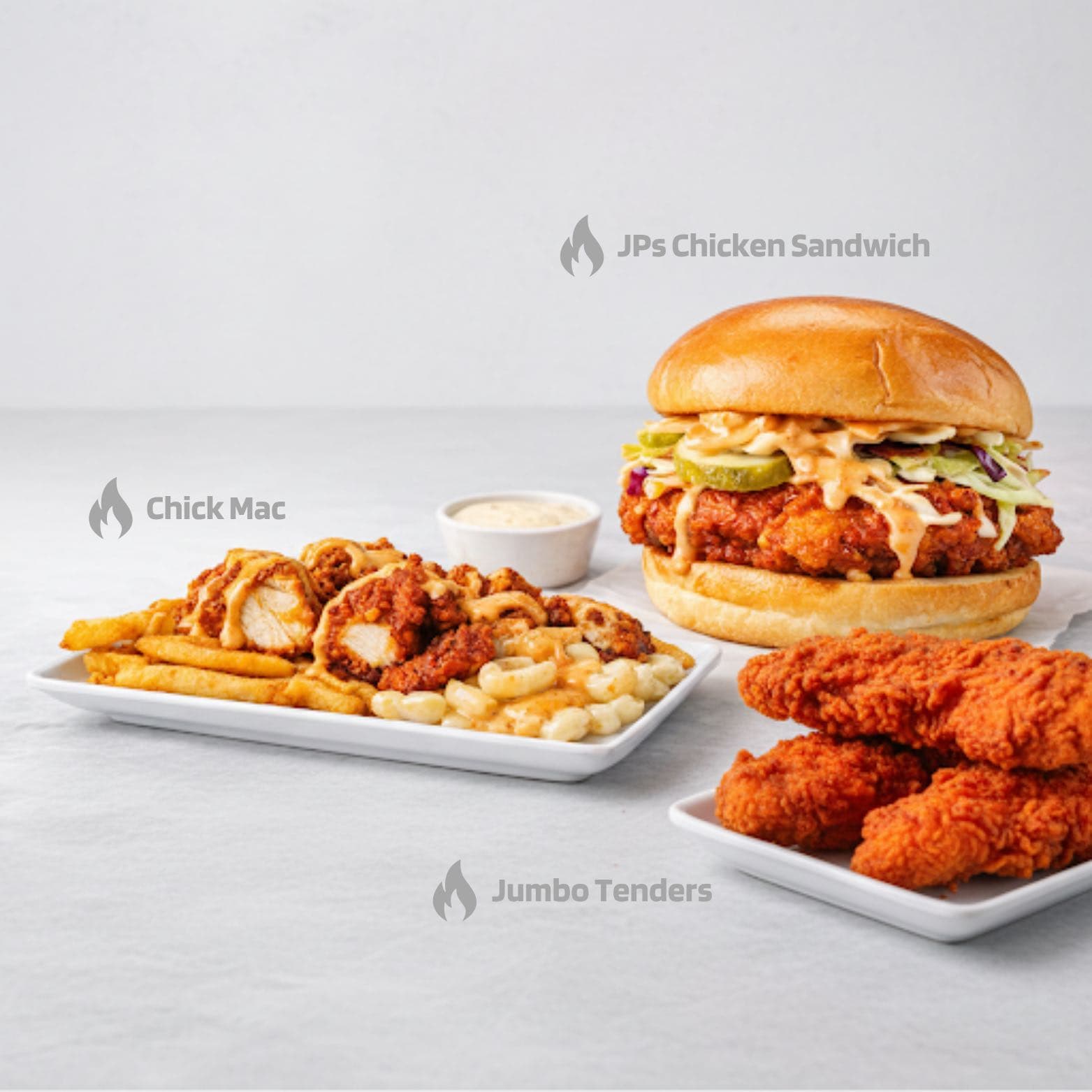 A spread of Nashville-style hot chicken from JP's Hot Chicken — sandwich, tenders, and loaded sides